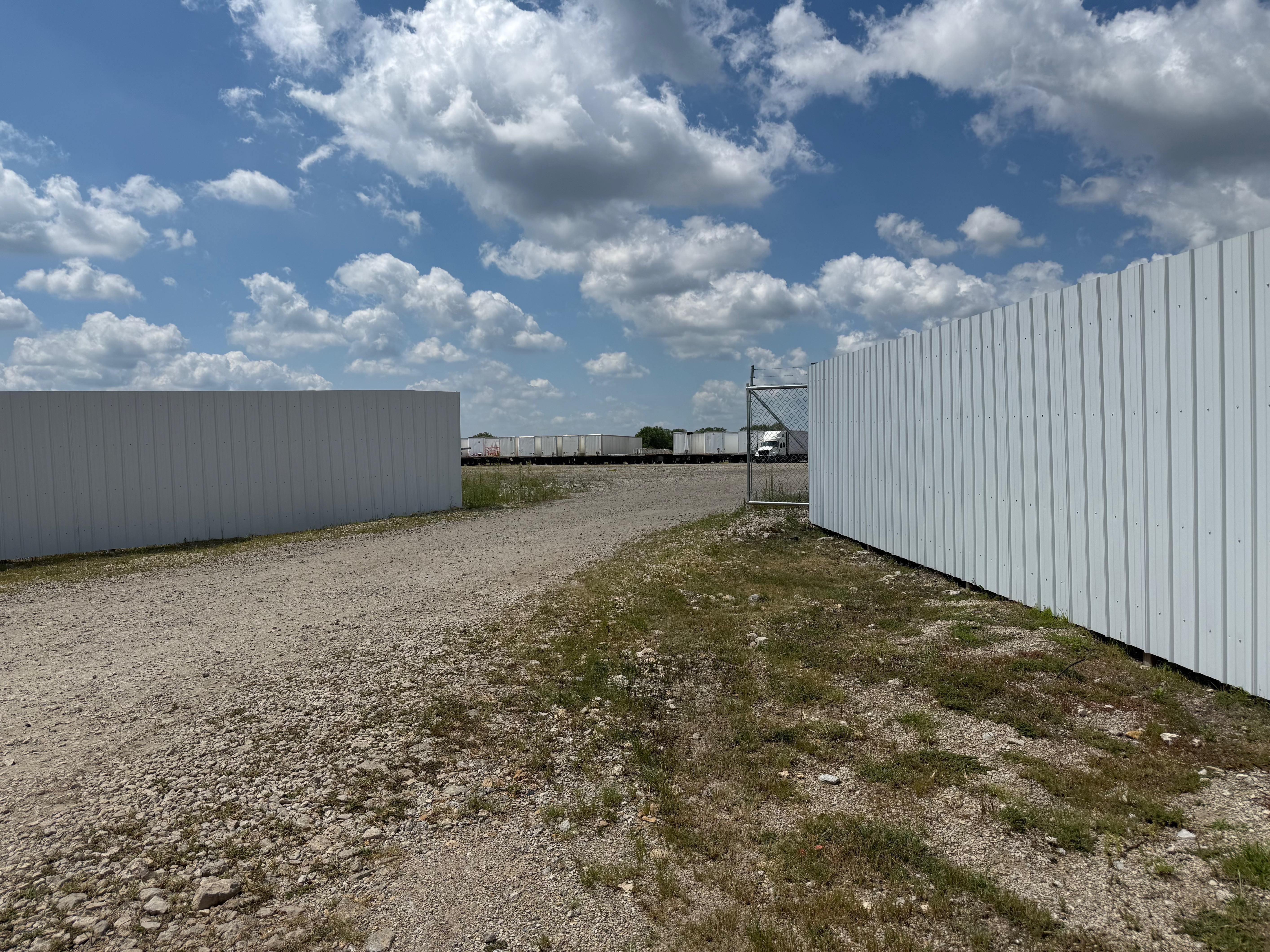 Secure outdoor storage yard with vinyl fencing and rail access